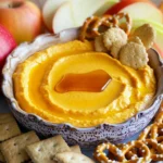 - 1 cup cream cheese, softened to room temperature - 1/2 cup powdered sugar - 1 cup canned pumpkin puree, preferably organic for richer flavor - 1 teaspoon pure vanilla extract - 1 teaspoon pumpkin pie spice blend - 1/2 teaspoon ground cinnamon - Graham crackers - Fresh apple slices - Pretzels Gathering the right ingredients is key. Cream cheese is the base. It brings a creamy texture. Use softened cream cheese for easy mixing. Next, powdered sugar adds sweetness. It balances the pumpkin flavor well. Canned pumpkin puree gives a rich taste. I like using organic for the best flavor. Pure vanilla extract adds depth to the mix. For spices, pumpkin pie spice blend is a must. It adds warmth and comfort to the dip. Ground cinnamon gives an extra kick. Together, they create that cozy fall flavor. Now, let’s talk about what to dip. Graham crackers are classic. They provide a nice crunch. Fresh apple slices add a juicy and refreshing contrast. Pretzels offer a salty bite that pairs well with the sweet dip. Mix and match these options for fun! First, start with your cream cheese. You want it softened, so let it sit out for about 30 minutes. This step is key. In a large mixing bowl, use an electric mixer to beat the cream cheese. Mix until smooth and creamy. Make sure there are no lumps. This should take about 2 minutes. Next, it's time to sweeten things up. Gradually sift in the powdered sugar. Keep mixing until it’s all blended in well. The mixture should be sweet and smooth, with no sugar clumps left. Now for the fun part! Grab your canned pumpkin puree. Add it into your cream cheese mix along with pure vanilla extract, pumpkin pie spice, and ground cinnamon. Mix on medium speed. You want everything to blend until it’s smooth and uniform. This step gives the dip its rich fall flavor, so don’t rush it! In a clean bowl, pour in the heavy whipping cream. Use a whisk or electric mixer to whip it. Keep going until stiff peaks form, which should take 2-3 minutes. Stiff peaks mean the cream holds its shape well. This adds airiness to your dip. Next, gently fold the whipped cream into your pumpkin mixture. Use a spatula and be careful not to deflate the whipped cream. This keeps your dip light and fluffy. Once combined, you're ready to serve! Room temperature cream cheese is key. It mixes easily and ensures a smooth dip. Cold cream cheese can create lumps. So, let your cream cheese sit out for about 30 minutes before using it. For whipped cream, stiff peaks are a must. Use a clean bowl and beat the heavy cream until it thickens. This usually takes about 2 to 3 minutes. Don't stop too soon! You want peaks to hold their shape when you lift the whisk. You can boost flavor with extra spices. Consider adding nutmeg, cloves, or ginger for a warm touch. These spices add depth and make the dip even more inviting. If you want a different sweetness, try using honey or maple syrup instead of powdered sugar. These natural options add flavor and a hint of richness. To impress, present the dip in a lovely bowl. Smooth the top for a nice look. Drizzle honey or maple syrup on the surface for shine. Surround the bowl with colorful dippers. Use graham crackers, fresh apple slices, and crunchy pretzels. This creates a fun, inviting platter that everyone will enjoy! {{image_4}} You can make this dip even more fun. Adding chocolate or caramel can bring a sweet twist. Just drizzle some chocolate sauce or mix in caramel for a rich taste. You can also try different spices. A pinch of nutmeg or ginger can add a nice kick. Experimenting with flavors can make each dip unique. Want a lighter dip? Use low-fat cream cheese instead of regular. This swap cuts some calories but keeps the creamy texture. You can also try using sweeteners like honey or agave syrup. These options can help reduce sugar while still being tasty. For a holiday-themed dip, you can add crushed candy canes or peppermint extract. This gives a festive touch for winter parties. You can also adapt the dip for other occasions by changing the toppings. For a summer gathering, top it with fresh berries. This makes the dip bright and colorful. Each season can bring new flavors to your pumpkin spice cheesecake dip! The Pumpkin Spice Cheesecake Dip lasts about 3 to 5 days in the fridge. To keep it fresh, cover your bowl tightly with plastic wrap or transfer it to an airtight container. This prevents it from absorbing other fridge smells and helps maintain its creamy texture. Yes, you can freeze the dip! To do this, place it in a freezer-safe container. Make sure to leave some space at the top, as the dip may expand when frozen. When you are ready to enjoy it, simply thaw it in the fridge overnight. To serve, stir it gently after thawing. This will help restore its smooth texture. Enjoy your dip with graham crackers or apple slices for a tasty treat! Yes, you can make this dip ahead of time. To do this, prepare the dip as directed. Once mixed, place it in a bowl and cover it with plastic wrap. Chill it in the fridge for at least 30 minutes. You can prepare it up to two days in advance. Just remember to keep it covered. This helps the flavors blend well. If you need a cream cheese substitute, use ricotta cheese or Greek yogurt. Both options work well and give a nice texture. For a dairy-free option, consider using vegan cream cheese. These alternatives keep the dip creamy and delicious. Adjust the sweetness as needed when using substitutes. Yes, this dip can be gluten-free. The main ingredients do not contain gluten. However, make sure to choose gluten-free dipping options like rice crackers or fresh fruit. Check labels carefully to ensure no gluten is present. This way, everyone can enjoy the dip at your fall party! This blog post covered how to make a delicious pumpkin spice cheesecake dip. We discussed the main ingredients like cream cheese and pumpkin puree, plus the right spices and flavors. You learned about prep steps and helpful tips for perfect texture. I also shared fun ways to serve it and tasty variations. Remember, this dip is perfect for fall gatherings or cozy nights at home. Try it out and enjoy each creamy bite!