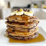 - 1 cup rolled oats - 1 scoop chocolate protein powder - 1 ripe banana, mashed - 2 large eggs - 1 teaspoon baking powder - ½ teaspoon vanilla extract - 1 cup milk (cow's or plant-based) - ¼ cup mini chocolate chips - Pinch of salt - Olive oil or non-stick spray The main ingredients for Chocolate Chip Protein Pancakes are simple yet effective. I use rolled oats because they add fiber and texture. The chocolate protein powder boosts nutrition while making the pancakes rich and tasty. A ripe banana acts as a natural sweetener and gives moisture. The eggs provide structure and help bind everything together. Baking powder makes the pancakes fluffy. Vanilla extract adds a lovely aroma, and milk brings it all together. I also love to mix in mini chocolate chips. They melt beautifully and give bursts of sweetness in each bite. Don’t forget the pinch of salt; it enhances all the flavors. Finally, I grease my skillet with olive oil or non-stick spray to keep the pancakes from sticking. - Fresh fruits (bananas, berries) - Maple syrup - Whipped cream - Nuts or seeds When it comes to toppings, the sky's the limit! Fresh fruits like bananas or berries add color and freshness. Maple syrup gives a sweet finish that complements the chocolate. Whipped cream adds a fun touch, while nuts or seeds can give extra crunch and nutrition. You can mix and match to create your perfect stack! Start by gathering your ingredients. In a high-speed blender, combine the following: - 1 cup rolled oats - 1 scoop chocolate protein powder - 1 ripe banana, mashed until smooth - 2 large eggs - 1 teaspoon baking powder - ½ teaspoon vanilla extract - 1 cup milk (cow's milk or any plant-based alternative) Blend these ingredients on high until you achieve a smooth batter. If the batter seems too thick, add a splash of milk. This adjustment helps get the right consistency. Once blended, pour the batter into a mixing bowl. Add in ¼ cup mini chocolate chips and fold them in gently. Make sure they spread evenly throughout the batter. Now, it's time to cook. Preheat a non-stick skillet over medium heat. Lightly grease it using olive oil or a quick spray of cooking spray. This step prevents sticking. For each pancake, pour about ¼ cup of batter onto the skillet. Cook them for 2-3 minutes. You will see bubbles forming on the surface when they are ready to flip. Gently flip the pancakes with a spatula. Cook for another 2-3 minutes until they turn golden brown. Remove them from the skillet and set aside. Repeat this with the remaining batter. Now for the fun part: serving. Stack your pancakes high and customize them with your favorite toppings. You can use: - Sliced fresh fruit - A drizzle of maple syrup - A sprinkle of extra chocolate chips For a beautiful presentation, layer the pancakes and drizzle with syrup. Top with banana slices and a final sprinkle of chocolate chips. This not only looks great but tastes wonderful too! To get soft and fluffy pancakes, your batter must be just right. The batter should not be too thick or too runny. When you blend your ingredients, look for a smooth, creamy texture. If it feels thick, add a splash of milk. This helps keep your pancakes light. To ensure even cooking, preheat your skillet over medium heat. After pouring the batter, watch for bubbles. When bubbles form, it’s time to flip. This shows the bottom is cooking well. If you have extra pancakes, store them in the fridge. Let them cool first. Then, place them in an airtight container. They will stay fresh for about three days. When you want to eat them again, reheat in a skillet or microwave. For the microwave, heat for about 30 seconds. Check if they are warm enough before enjoying. You can add more fun to your pancakes with mix-ins. Try walnuts, blueberries, or even a pinch of cinnamon. Each adds a unique taste. Adjust the sweetness by adding more or less banana. If you like it sweeter, drizzle some maple syrup on top. You can also use honey or agave as a natural sweetener. {{image_4}} You can change the protein powder for different flavors. Vanilla protein powder works great. If you want a plant-based option, use plant protein. It gives a nice taste, too. For a vegan twist, try using flax eggs or applesauce instead of eggs. Mix one tablespoon of flaxseed with three tablespoons of water. Let it sit for a few minutes until it thickens. Spices can add a special touch to your pancakes. Try mixing in a pinch of cinnamon or nutmeg for warmth. You can also toss in some chopped nuts or dried fruits like raisins or cranberries. These add texture and flavor, making your pancakes even tastier. Toppings can elevate your pancake experience. Fresh fruit like bananas or berries adds sweetness and color. A drizzle of maple syrup or honey gives a lovely finish. If it’s fall, consider adding pumpkin puree or pecans for a seasonal twist. For extra fun, try a scoop of yogurt or a sprinkle of granola on top! Protein helps build and repair muscles. It is key for recovery after exercise. Eating enough protein can keep you feeling full. This helps with weight management. Protein pancakes are a tasty way to add protein to your breakfast. They provide energy and satisfaction to start your day. Each serving of these pancakes has about 350 calories. You get around 20 grams of protein, 45 grams of carbs, and 10 grams of fat. The rolled oats give you fiber, which is good for digestion. The banana adds natural sweetness and potassium. The chocolate protein powder boosts the protein content and flavor. If you need gluten-free options, use certified gluten-free oats. You can swap ingredients easily for dietary needs. For lactose-free, try almond milk or oat milk. If you want a vegan version, replace eggs with flaxseed meal or a banana. Adjust the recipe to suit your needs while still enjoying these delicious pancakes. You can make these pancakes gluten-free by using certified gluten-free oats. Not all oats are gluten-free, so check the label. You can also replace rolled oats with almond flour or coconut flour. If you choose coconut flour, use less, as it absorbs more liquid. Yes, you can freeze these pancakes. First, let them cool completely. Then, stack them with parchment paper between each one. Place them in a freezer bag or container. To reheat, microwave them for about 30 seconds or toast them in a skillet until warm. Absolutely! You can use any milk you like. Almond milk, soy milk, or oat milk work great. Just make sure to choose unsweetened versions to keep the flavor balanced. Each milk adds a unique taste, so feel free to experiment. Store leftover pancakes in an airtight container in the fridge. They will stay fresh for about three days. To keep them warm, you can place them in an oven set at a low temperature until ready to eat. You can customize the flavor in many fun ways. Try adding a teaspoon of cinnamon or a scoop of peanut butter. You can also mix in chopped nuts, dried fruits, or different types of chocolate chips. This way, you can create a new twist each time! These protein-packed pancakes are both easy and fun to make. You learned about the key ingredients, steps, and tips for success. The options for variations and toppings give you a chance to get creative. Remember, these pancakes can suit many diets and taste preferences. They offer good nutrition while tasting fantastic. Enjoying a healthy breakfast can be simple and delicious with this recipe. Try it out, and watch how it can brighten your mornings!