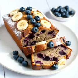 - 3 ripe bananas, thoroughly mashed - 1 cup fresh blueberries (adjust for frozen if needed) - 1/2 cup unsalted butter, softened - 3/4 cup granulated sugar - 2 large eggs, at room temperature - 1 teaspoon pure vanilla extract - 1 teaspoon baking soda - 1/2 teaspoon baking powder - 1/4 teaspoon salt - 1 1/2 cups all-purpose flour - Optional: 1/2 teaspoon ground cinnamon To make blueberry banana bread, you need ripe bananas. They add sweetness and moisture. Fresh blueberries burst with flavor. If you can't find fresh, frozen works too. Use unsalted butter for a rich taste. Granulated sugar sweetens the bread nicely. Eggs help bind the ingredients and add fluffiness. Pure vanilla extract gives a warm, inviting aroma. Baking soda and baking powder help the bread rise. Salt balances the sweetness. All-purpose flour gives the right texture. If you love spice, add ground cinnamon for warmth. Each ingredient plays a key role in crafting a moist, tasty loaf. - Calories per serving: About 180 - Total fat: 7g - Carbohydrates: 26g - Protein: 2g Blueberries and bananas are not just tasty. They also pack a nutritious punch. Blueberries are rich in antioxidants. They support heart health and may boost memory. Bananas provide potassium and fiber. They help with digestion and keep you full. Enjoy this bread knowing it offers both flavor and health benefits. {{ingredient_image_2}} - Preheat oven to 350°F (175°C) - Grease or line a 9x5 inch loaf pan First, I start by preheating my oven to 350°F (175°C). This step warms the oven for even baking. Next, I prepare a 9x5 inch loaf pan. I grease it lightly with butter or use parchment paper. This helps the bread come out easily after baking. - Mash ripe bananas - Combine bananas with butter, sugar, eggs, and vanilla Now, I take three ripe bananas. I mash them in a large bowl until smooth. You can use a fork or a potato masher. Then, I add half a cup of softened butter to the mashed bananas. I mix them until creamy. Next, I add three-quarters of a cup of sugar, two large eggs, and one teaspoon of vanilla extract. I blend everything well until smooth. - Mix dry ingredients separately - Incorporate dry mix into wet mixture In another bowl, I whisk together the dry ingredients. This includes one and a half cups of all-purpose flour, one teaspoon of baking soda, half a teaspoon of baking powder, and a quarter teaspoon of salt. If I want extra warmth, I add half a teaspoon of ground cinnamon. Once mixed, I gradually add the dry ingredients to the wet mixture. I stir gently until just combined. It’s okay if there are a few lumps. - Fold in blueberries - Transfer to pan and bake for 60-70 minutes Finally, I fold in one cup of fresh blueberries. I make sure they spread evenly in the batter. Then, I pour the batter into the prepared loaf pan. I smooth the top with a spatula. I place the pan in the oven and bake for 60 to 70 minutes. Around the 55-minute mark, I check for doneness. I insert a toothpick into the center. It should come out clean or with a few moist crumbs. After baking, I let the bread cool in the pan for about 10 minutes. Then, I transfer it to a wire rack to cool completely. To make the best banana bread, avoid over-mixing the batter. Mix just enough so the flour blends in. This keeps your bread soft and fluffy. Also, use room temperature eggs. They mix in better and help create a nice texture. You might want to add ground cinnamon for warmth. It gives the bread a cozy taste. If you want to change the sweetness, try using honey or maple syrup instead of granulated sugar. This can add a unique flavor twist. When slicing your banana bread, aim for even pieces. Arrange them on a rustic wooden board for an inviting look. For a pop of color, garnish with fresh blueberries and banana slices. A light dusting of powdered sugar adds sweetness and makes it look fancy. Pro Tips Use Overripe Bananas: The riper the bananas, the sweeter and more flavorful your bread will be. Look for bananas with brown spots for the best results. Don't Overmix: When combining the wet and dry ingredients, mix until just combined. Overmixing can lead to a dense bread texture. Experiment with Spices: Adding spices like nutmeg or ginger along with cinnamon can enhance the flavor profile and add warmth to your bread. Storage Tips: Store the banana bread in an airtight container at room temperature for up to 3 days or refrigerate for longer freshness. You can also freeze slices for up to 3 months. {{image_4}} You can make a few simple swaps in this recipe. One great option is to use applesauce instead of butter. This change cuts down on fat and adds some natural sweetness. You can also try whole wheat flour. This makes your banana bread healthier while still tasting great. Want to change the taste? Adding nuts like walnuts or pecans gives a nice crunch. You can also infuse the bread with warm spices like nutmeg or allspice. These spices add a cozy flavor that pairs well with the sweetness of the bananas and blueberries. If you need gluten-free options, use gluten-free flour instead of all-purpose flour. This keeps your bread light and tasty. For a vegan twist, replace the eggs with flaxseed meal mixed with water. You can also use coconut oil or more applesauce instead of butter. These swaps let everyone enjoy this delicious treat! To keep your blueberry banana bread fresh, wrap it well. Use plastic wrap or aluminum foil. This helps prevent it from drying out. You can also store it in an airtight container. It stays tasty for about 3-4 days at room temperature. If you want to keep it longer, refrigeration is an option. However, this may change its texture slightly. Freezing is a great way to save banana bread for later. First, let the bread cool completely. Then, wrap it tightly in plastic wrap. Follow this with a layer of aluminum foil. This double wrap keeps it safe from freezer burn. You can freeze banana bread for up to 3 months. When you’re ready to enjoy it, thaw the bread in the fridge overnight. For a warm treat, you can reheat it in the oven. Set the oven to 350°F (175°C) and bake for 10-15 minutes. This revives its soft texture and enhances the flavor. To know if your blueberry banana bread is done, use the toothpick test. Insert a toothpick into the center of the bread. If it comes out clean or has a few moist crumbs, your bread is ready. I suggest checking around 55 minutes of baking time. This way, you avoid overbaking. Remember, the bread will continue to cook a little after you take it out. Yes, you can use frozen blueberries. They work well in this recipe. When using frozen blueberries, do not thaw them. Adding them straight from the freezer helps keep the batter cold. This prevents the berries from bleeding too much color and juice into the bread. Just gently fold them in for the best results. Blueberry banana bread lasts about 3 to 4 days at room temperature. Store it in an airtight container. If you refrigerate it, it can last up to a week. The cold helps keep it fresh for longer. Just remember to let it sit at room temperature before serving for the best taste. This blog post covers everything you need for perfect blueberry banana bread. We started with key ingredients, highlighting ripe bananas and fresh blueberries for the best taste. Then, I detailed easy steps for mixing and baking. Tips on flavor enhancement and variations help you get creative with your loaf. Remember to store it right to keep it fresh. With these tips, you can make a delicious, homemade treat that impresses everyone. Enjoy your baking adventure!